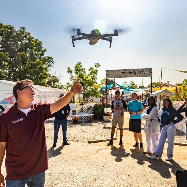 Mutiple media - GIS professor teaching students about drones